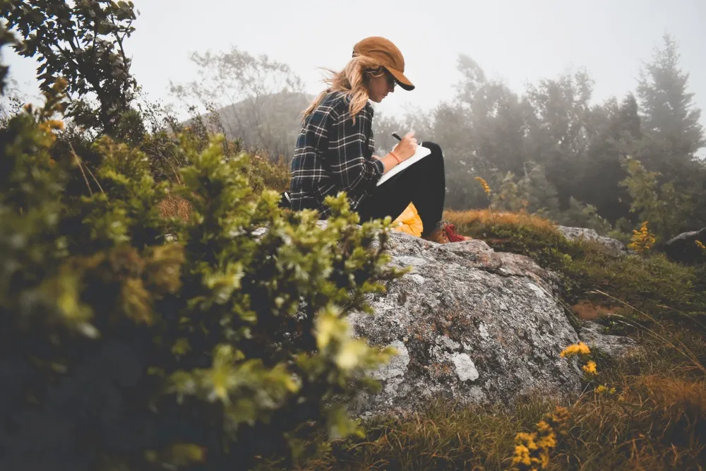 woman writing surrounded by nature