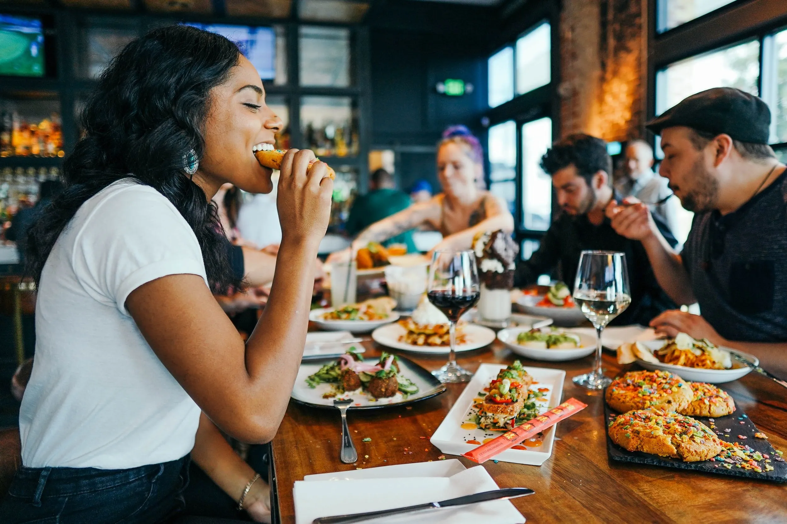people eating in a table full of food