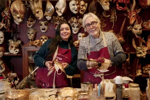 Two artisans painting Venetian masks